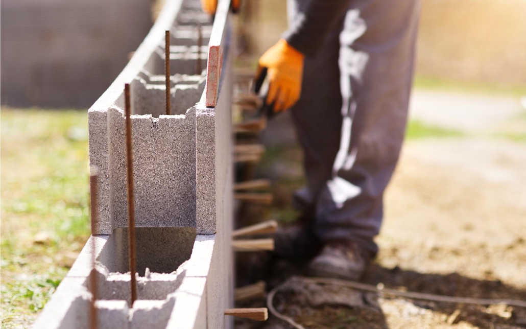 Image of a worker installing concrete masonry