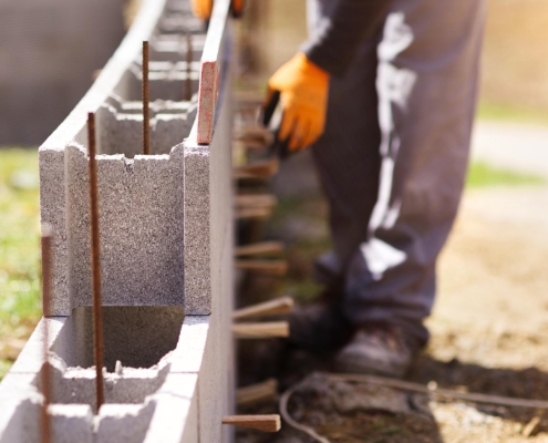 Image of a worker installing concrete masonry